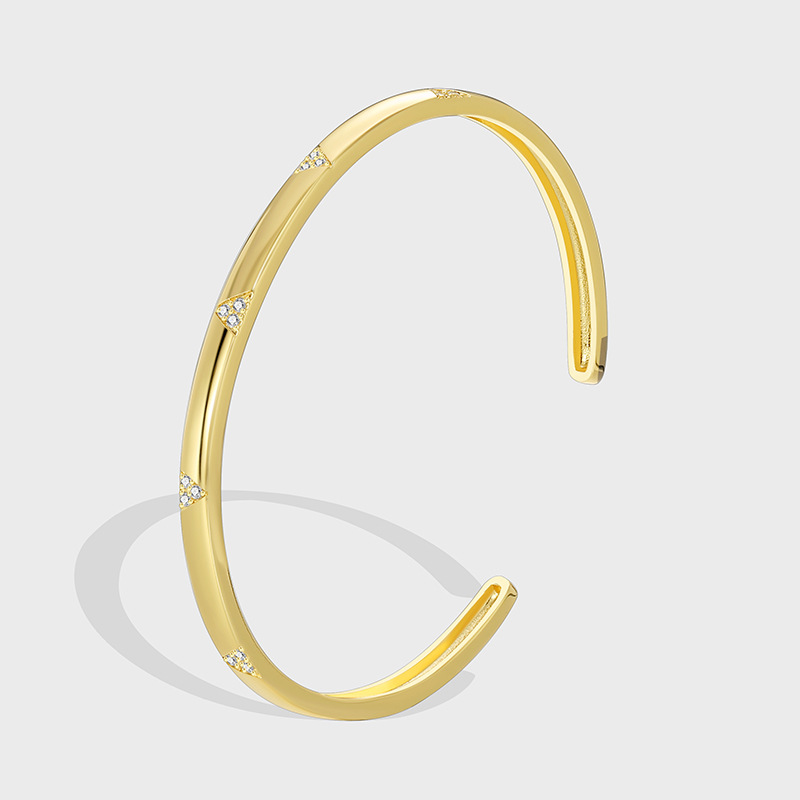 Gold sculptural curved bangle