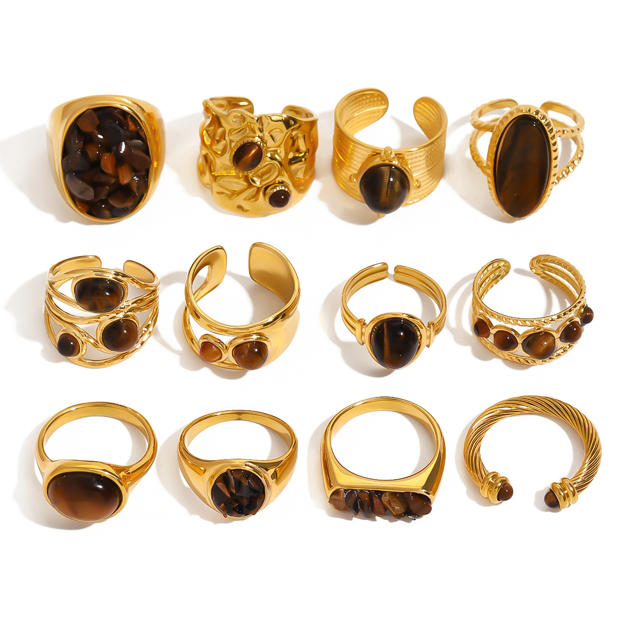 Display grid of twelve gold-plated rings with dark stone embellishments